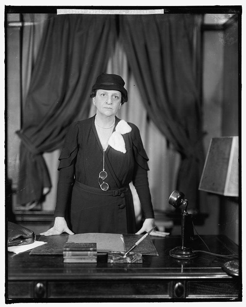 Head-and-shoulders portrait of Frances Perkins wearing a dark hat.