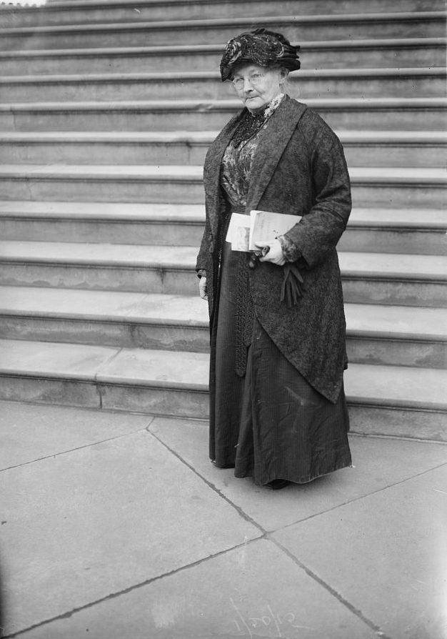 Portrait of Mother Jones wearing a dark coat and hat.